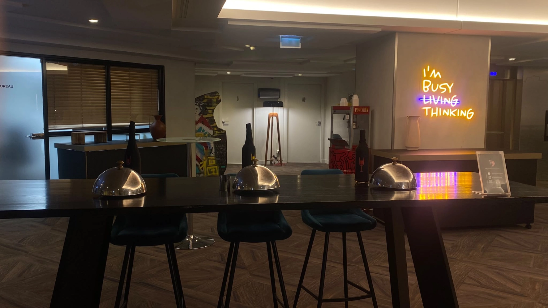 Image d'une table en long, sur laquelle il y a trois plat sous cloche