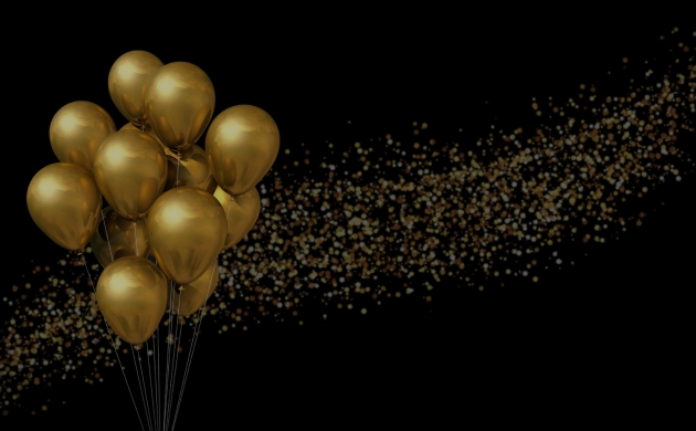 Ballons dorés sur fond noir accompagnés d’une traînée de confettis scintillants, illustrant une célébration d’anniversaire.